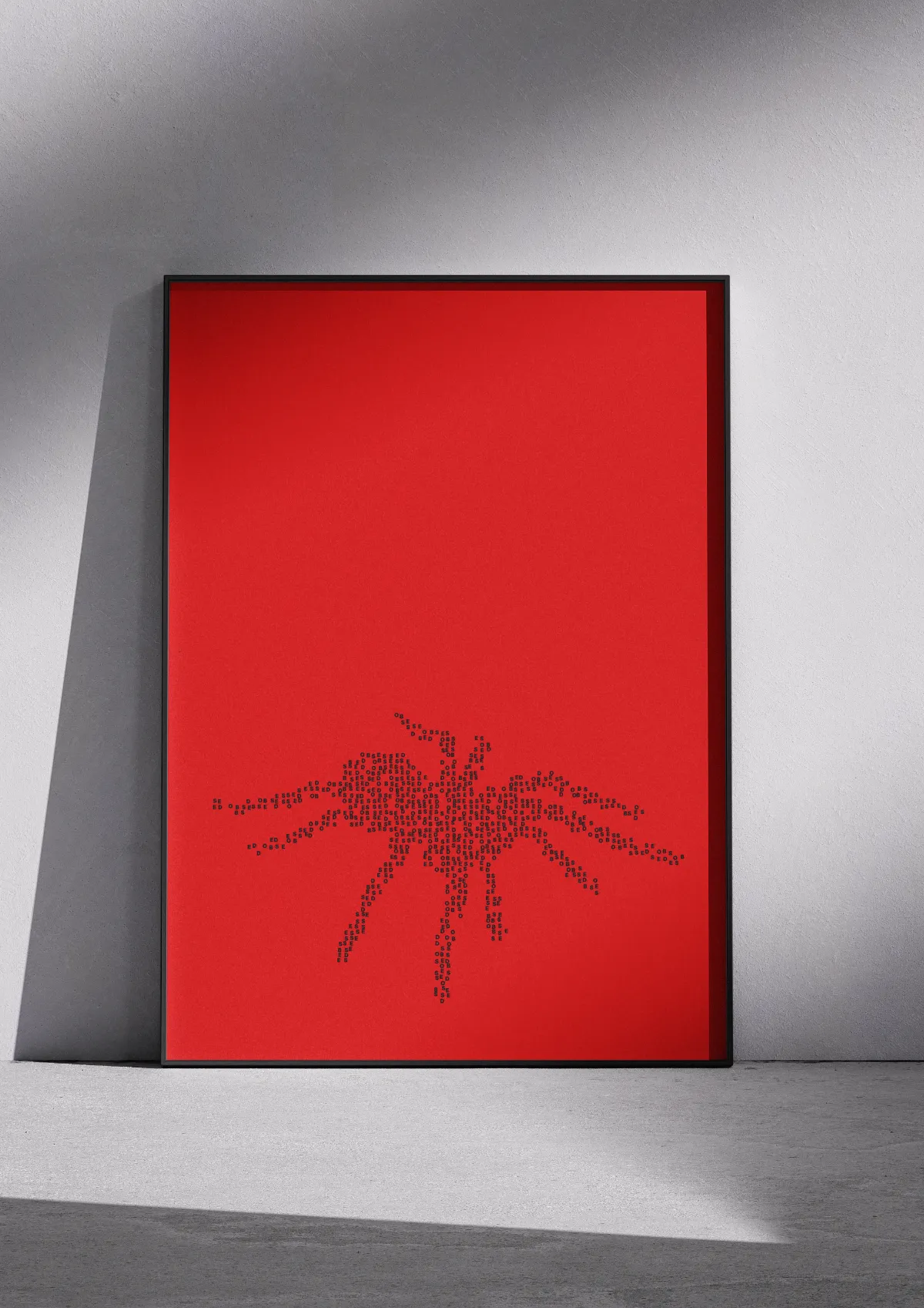 Typographic poster "Obsessed", black on red, framed on a wall. A spider.